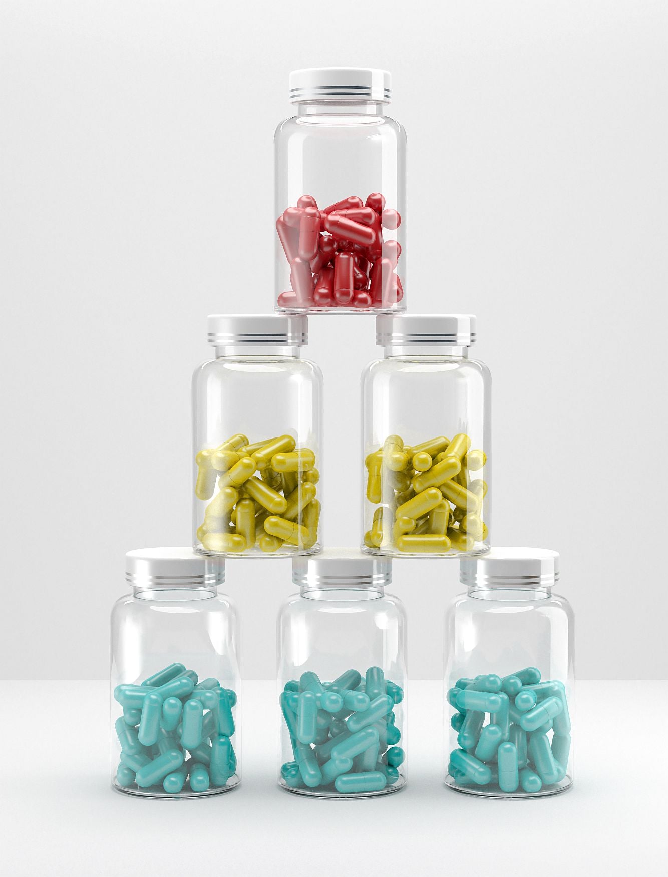stack of glass medicine bottles with pills different colours