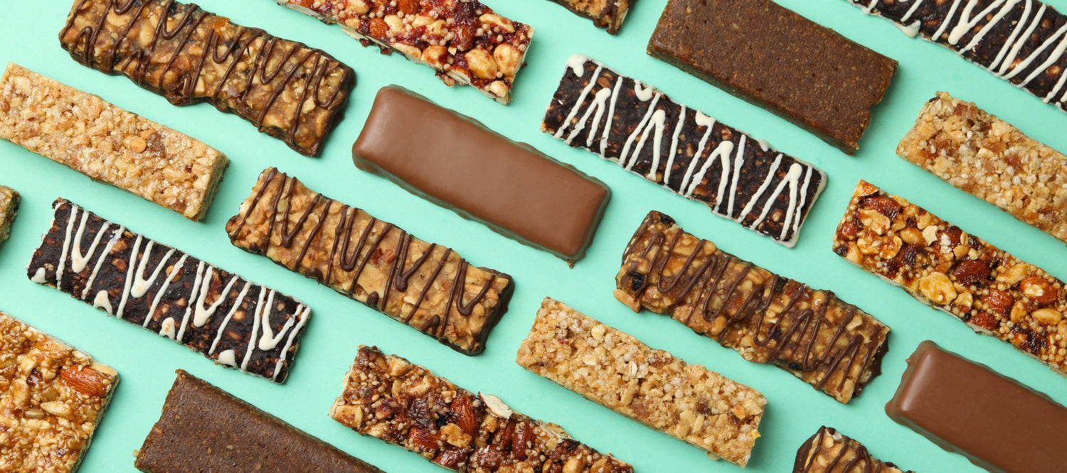 "Assorted protein bars in popular flavors like chocolate sea salt, peanut butter cookie dough, and strawberry shortcake, displayed for private label trends